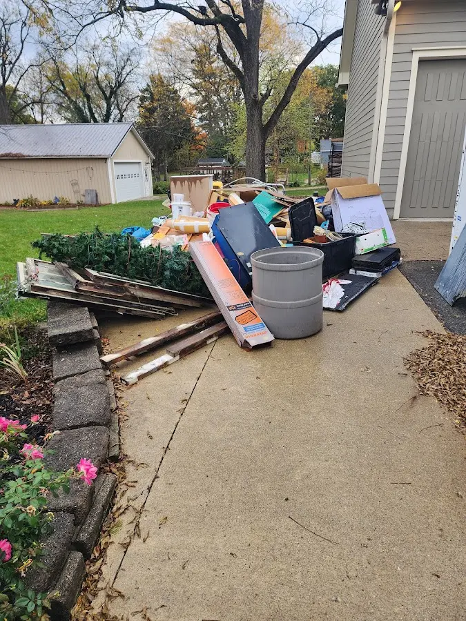 Dumpster being loaded with debris for 12 Yard Dumpster Rental in Fort Pierce